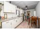 Bright kitchen featuring white cabinets, granite countertops, stainless steel appliances, and wood-look floors at 607 E Granville St, Dunn, NC 28334