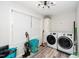 Bright laundry room features a large window, modern washer and dryer, and ample storage space at 607 E Granville St, Dunn, NC 28334