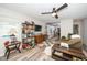 Bright living room featuring wood-look flooring, ceiling fan, and an open view to the kitchen at 607 E Granville St, Dunn, NC 28334