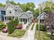 Aerial view of a well-maintained home with beautiful landscaping, a private driveway, and lush greenery at 616 Dorothea Dr, Raleigh, NC 27603