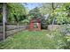 Cozy backyard featuring a wooden shed with a sliding glass door and a well-maintained lawn at 616 Dorothea Dr, Raleigh, NC 27603