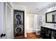 Bright bathroom featuring stacked washer/dryer unit and modern fixtures at 616 Dorothea Dr, Raleigh, NC 27603