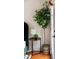 Bedroom corner with a stylish side table, decorative lamp, and a large potted plant at 616 Dorothea Dr, Raleigh, NC 27603
