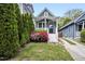 Quaint home with a charming front porch, stone steps, and beautiful rose bushes at 616 Dorothea Dr, Raleigh, NC 27603