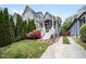 Charming home featuring a welcoming front porch and beautifully landscaped yard with colorful flowers at 616 Dorothea Dr, Raleigh, NC 27603