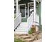 Inviting front porch with fresh white paint, black door and stone steps at 616 Dorothea Dr, Raleigh, NC 27603