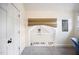 Hallway with carpeted floors, bright white walls, and access to storage space at 616 Dorothea Dr, Raleigh, NC 27603