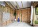 Bright shed interior with exposed wood framing, white rug, and a macrame wall hanging at 616 Dorothea Dr, Raleigh, NC 27603