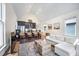 Open concept living room with island seating, stainless steel appliances, and hardwood flooring at 616 Dorothea Dr, Raleigh, NC 27603