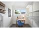 Bright home office with a large window, stylish desk, blue chair and modern storage at 616 Dorothea Dr, Raleigh, NC 27603