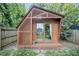 Stylish wooden shed featuring a slatted design and glass sliding doors, set in a green yard at 616 Dorothea Dr, Raleigh, NC 27603