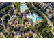 Aerial view of community pool with multiple swimming areas, lounge seating, and trees at 638 Boulder Point Dr, Chapel Hill, NC 27516