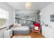 This bedroom has a cozy daybed, decorative city mural and warm, wood floors at 638 Boulder Point Dr, Chapel Hill, NC 27516