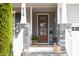 A welcoming front porch with stone pillars, a wreath on the door, and charming decor at 638 Boulder Point Dr, Chapel Hill, NC 27516