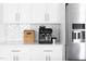 Modern kitchen with stainless steel refrigerator, coffee machine, and white cabinets at 638 Boulder Point Dr, Chapel Hill, NC 27516