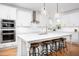 Well-lit kitchen with white cabinets, stainless steel appliances, and island seating at 638 Boulder Point Dr, Chapel Hill, NC 27516