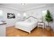 Bright main bedroom with white decor, hardwood floors, and abundant natural light creates a cozy, airy retreat at 638 Boulder Point Dr, Chapel Hill, NC 27516