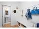 Bright mudroom features storage bench with hooks and a view to the powder room, perfect for organization at 638 Boulder Point Dr, Chapel Hill, NC 27516