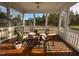 Relaxing screened porch with wooden furniture overlooking a landscaped backyard at 638 Boulder Point Dr, Chapel Hill, NC 27516