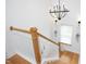 Bright staircase with wood and white railing design and modern chandelier provides a stylish transition at 638 Boulder Point Dr, Chapel Hill, NC 27516