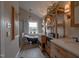 Stylish bathroom with a vintage clawfoot bathtub, a glass shower, and custom wooden shelving for storage at 754 Epps Clark Rd, Siler City, NC 27344