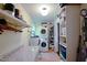 Functional laundry room with stacked washer and dryer, storage shelves, and counter space at 754 Epps Clark Rd, Siler City, NC 27344