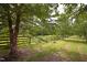 Green yard with wooden fence at 754 Epps Clark Rd, Siler City, NC 27344