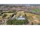 Aerial view of a rural property showcasing fields, trees, and multiple buildings, including a large barn at 754 Epps Clark Rd, Siler City, NC 27344
