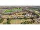 An aerial view of the property with fields, ponds, trees and several structures, including a farmhouse and outbuildings at 754 Epps Clark Rd, Siler City, NC 27344