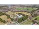 Bird's eye view of an estate with open fields, a pond, main residence, and outbuildings surrounded by forest at 754 Epps Clark Rd, Siler City, NC 27344