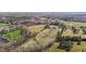 An aerial view of the property with fields, ponds, trees and several structures, including a farmhouse and outbuildings at 754 Epps Clark Rd, Siler City, NC 27344