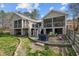 Exterior backyard view with a stone patio, screened-in porch, and outdoor entertaining space at 754 Epps Clark Rd, Siler City, NC 27344