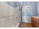 Well-lit bathroom equipped with a shower-tub combo, vanity, and neutral wall color at 754 Epps Clark Rd, Siler City, NC 27344