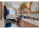 Charming bathroom featuring dual vanities, stylish tile flooring, and a vintage soaking tub at 754 Epps Clark Rd, Siler City, NC 27344