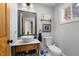 Charming powder room featuring a vessel sink, stylish vanity, and eye-catching decorative tile floor at 754 Epps Clark Rd, Siler City, NC 27344
