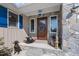 Inviting front porch with stone accents, a dark wood door, blue shutters, and decorative details at 754 Epps Clark Rd, Siler City, NC 27344