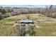 Aerial view of horse farm featuring barn, paddocks and multiple horses grazing in pasture at 754 Epps Clark Rd, Siler City, NC 27344