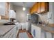 Efficient kitchen layout with essential appliances, countertop space, and convenient access to laundry area at 754 Epps Clark Rd, Siler City, NC 27344