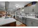Bright kitchen with gray cabinetry, farmhouse sink, stainless steel appliances, and hardwood floors at 754 Epps Clark Rd, Siler City, NC 27344