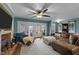 Bright living room featuring a brick fireplace, comfortable seating, and French doors to an outdoor space at 754 Epps Clark Rd, Siler City, NC 27344