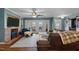 Cozy living room with a brick fireplace, comfortable seating, and French doors leading to the outside at 754 Epps Clark Rd, Siler City, NC 27344