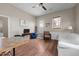 Open living room with light-colored walls, wood-look floors, ceiling fan, and outdoor access at 754 Epps Clark Rd, Siler City, NC 27344