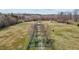Aerial view of horse property features gated entrance, mature trees, and pasture at 754 Epps Clark Rd, Siler City, NC 27344