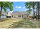 Large backyard featuring grass, privacy fence, and exterior view of the home with patio at 8300 Neuse Hunter Dr, Raleigh, NC 27616