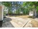 Spacious backyard featuring a concrete patio, a shed, mature trees, and a wooden privacy fence at 8300 Neuse Hunter Dr, Raleigh, NC 27616