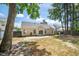 Backyard view with a patio, privacy fence, mature trees, and exterior view of the home at 8300 Neuse Hunter Dr, Raleigh, NC 27616
