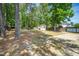 Spacious backyard featuring mature trees, a wood privacy fence, and a shed at 8300 Neuse Hunter Dr, Raleigh, NC 27616