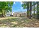 Large, well-maintained backyard with mature trees and a patio area at 8300 Neuse Hunter Dr, Raleigh, NC 27616
