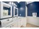 Inviting bathroom featuring a double vanity, framed mirrors, and elegant lighting at 8300 Neuse Hunter Dr, Raleigh, NC 27616