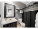 Modern bathroom featuring updated vanity, black accents, and a shower with a stylish curtain at 8300 Neuse Hunter Dr, Raleigh, NC 27616